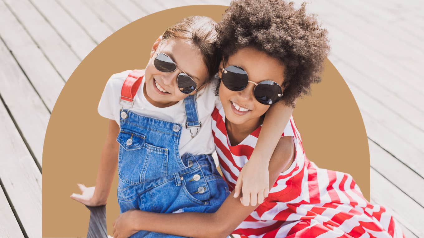 Why I Don't Want My Daughter To Have A Best Friend little girl best friends sitting on a dock together hugging