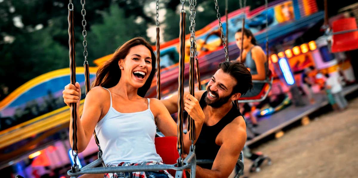 husband and wife having fun at a carnival
