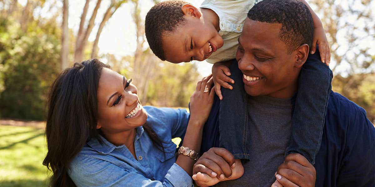 happy couple with playing with their child