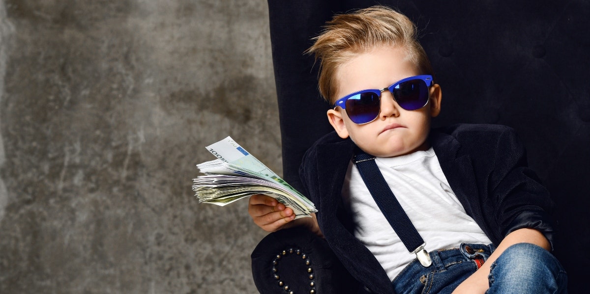 kid showing off his stack of cash