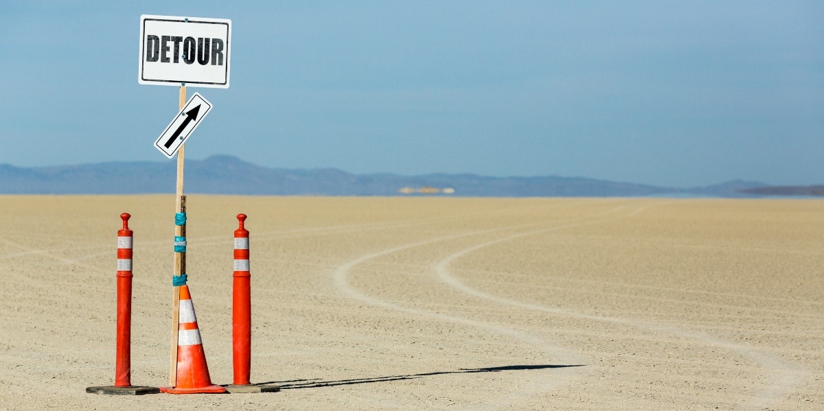 detour sign in the sand