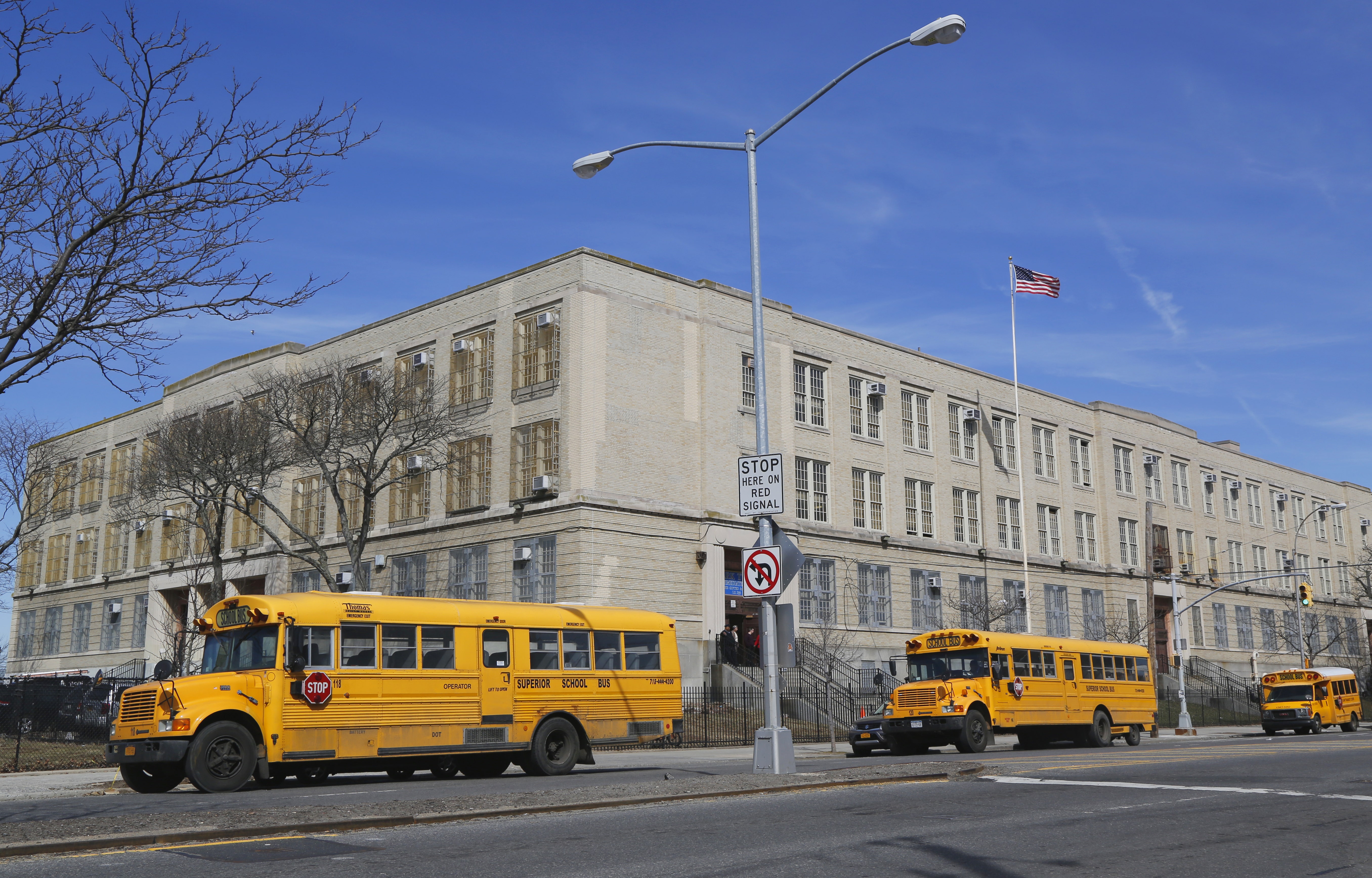 school buses in front of school