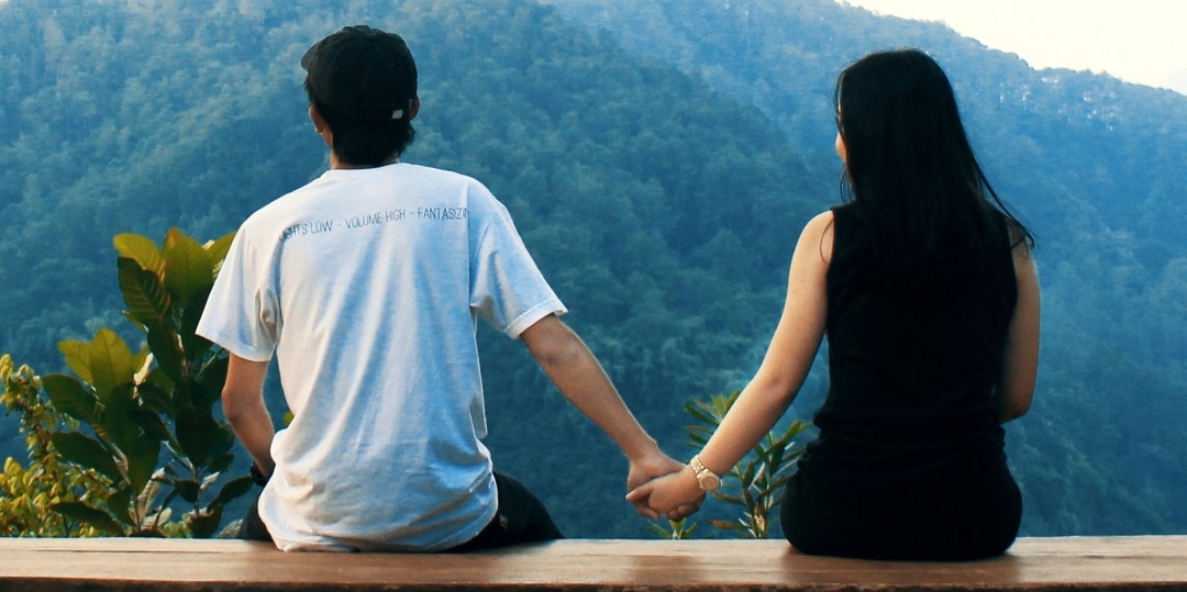 couple holding hands at overlook