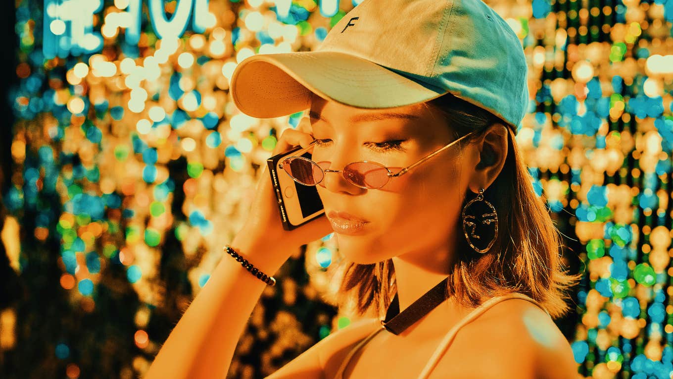 5 Tiny Signs You're Not Taking Good Care Of A Friendship woman looking down while on the phone, feeling guilty