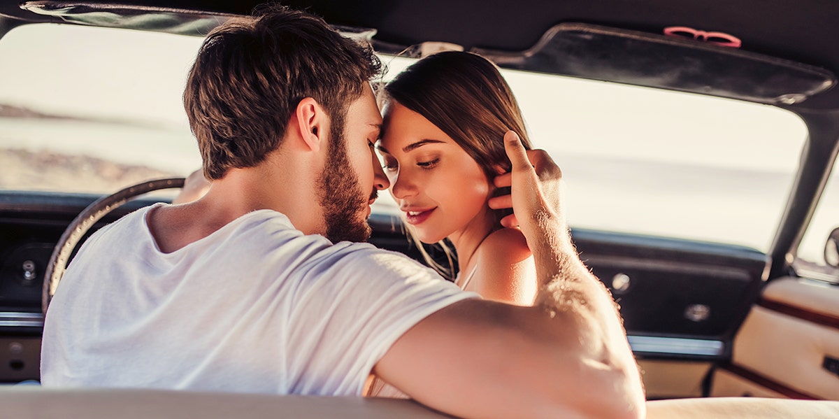 man and woman about to kiss in a car
