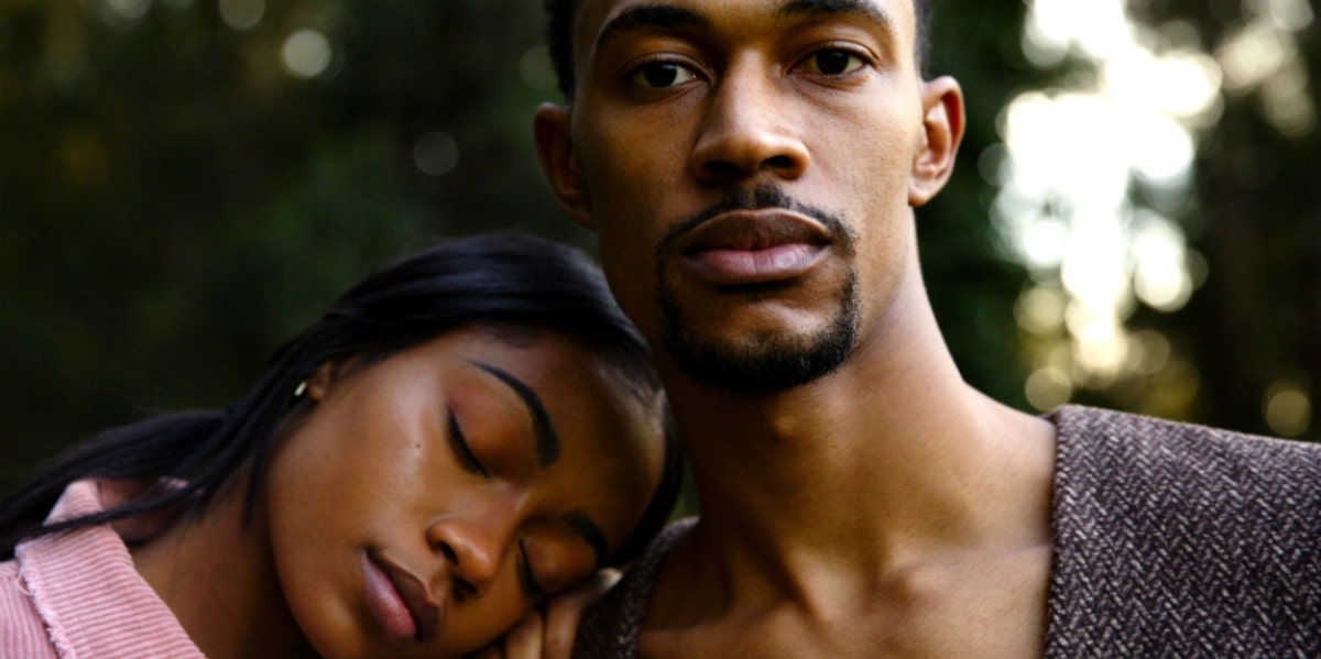 couple with woman's head on man's shoulder