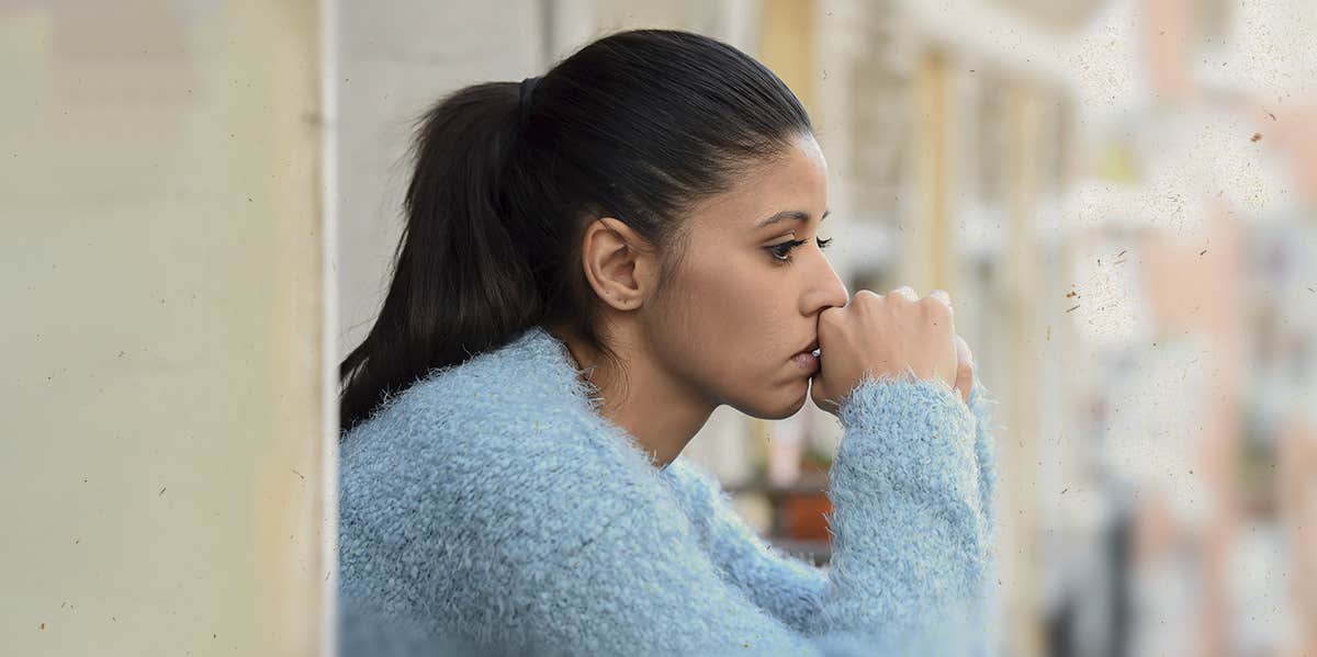 woman looking out, looking sad