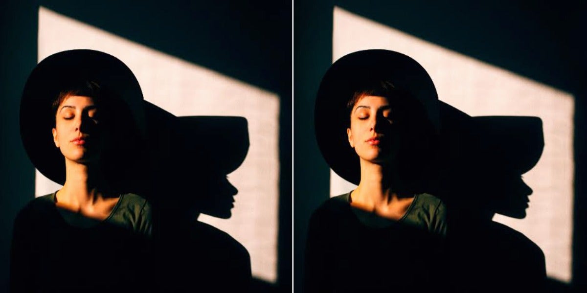 woman in hat sitting in the dark