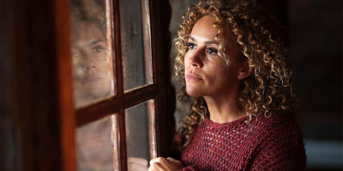 12 Spiritual & Psychic Signs From The Universe That You Are On The Wrong Path woman looking out the window