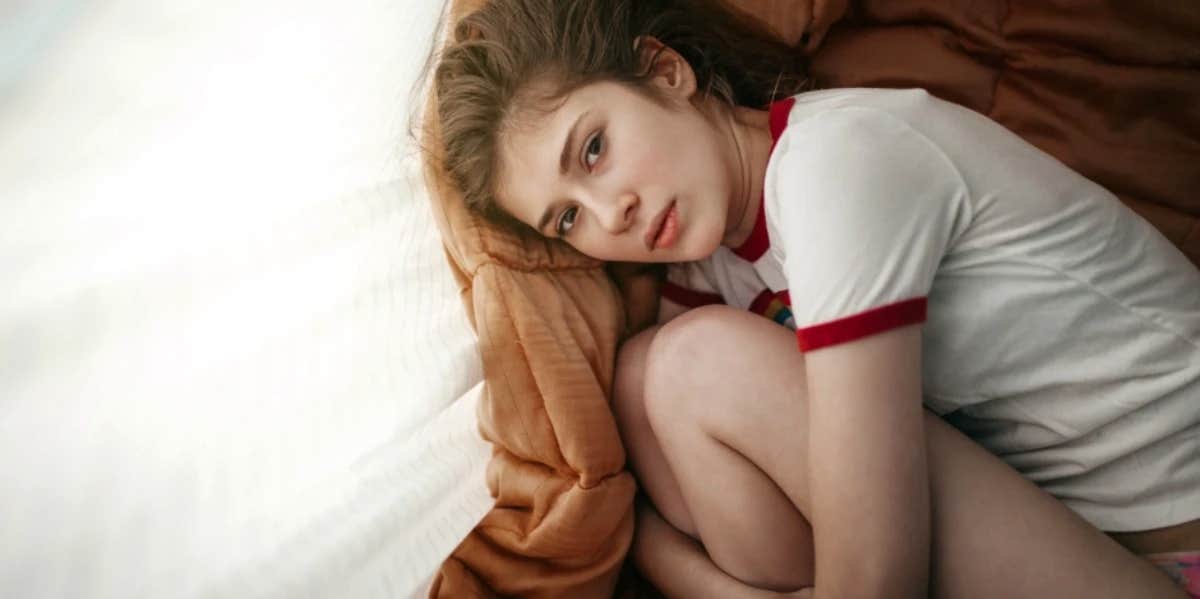 11 Signs He's Tired Of You (And Fed Up With Your Relationship) An introspective woman lays in the fetal position
