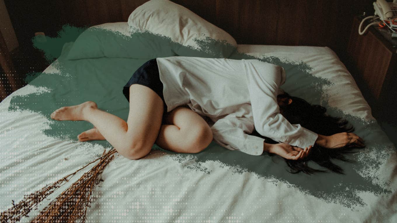 woman laying on bed sad