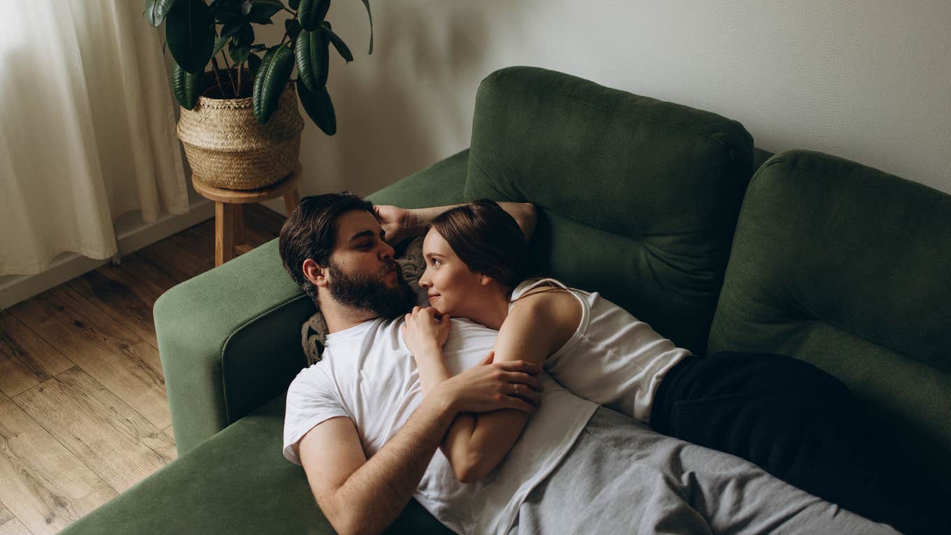 5 Uncomfortable Signs The Man You Love Doesn't Love You Back couple laying on the couch together