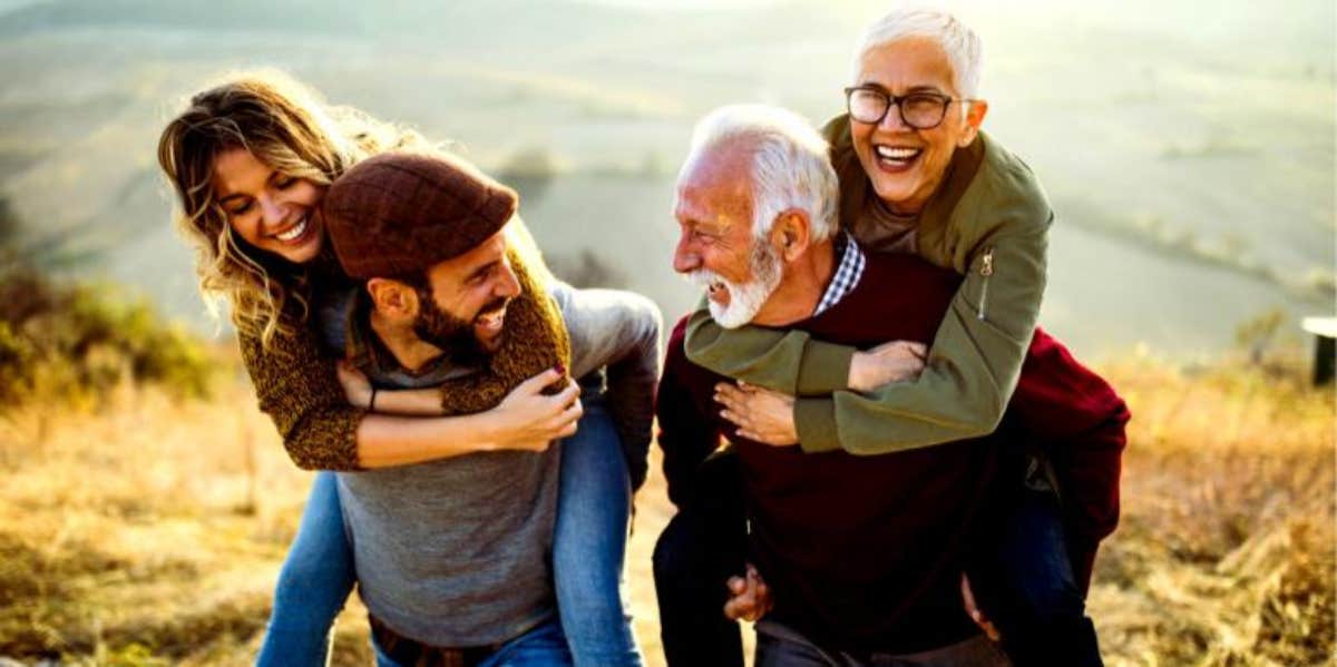 younger and older couple laughing and enjoying each other's company together