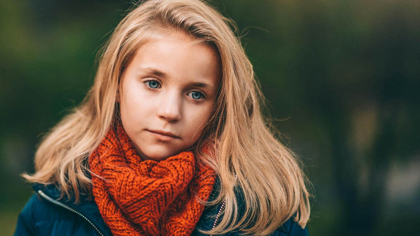little blond girl in a red scarf