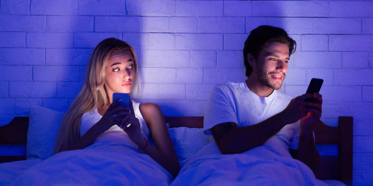 Experts Reveal The Social Media Habits That Prove A Husband Is Unhappy In His Marriage woman watching her man on his phone
