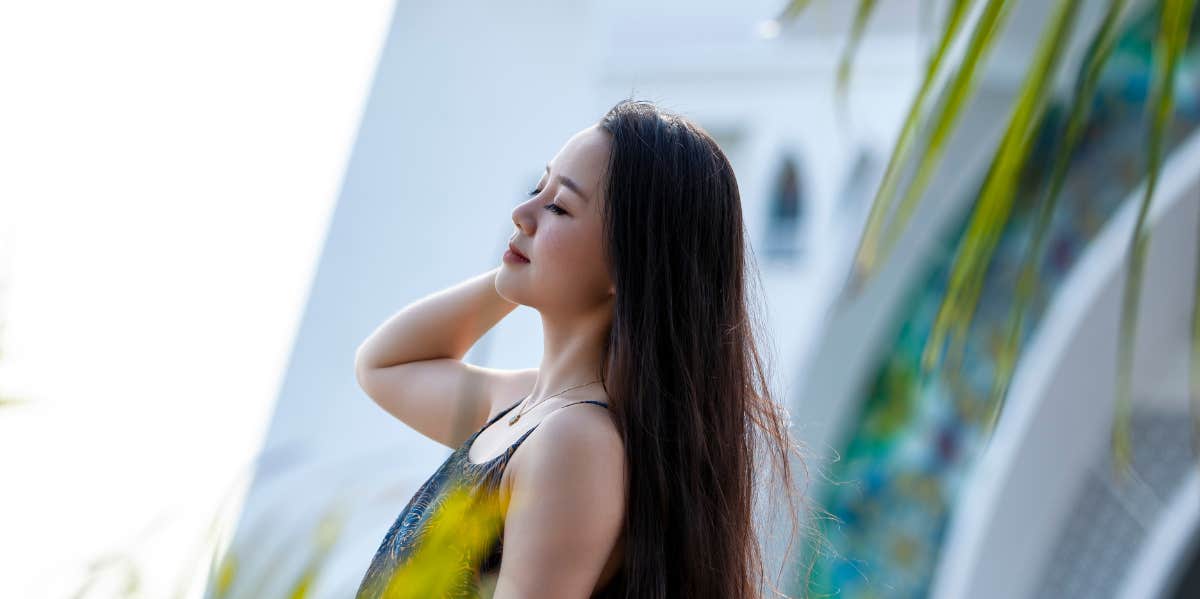 woman surrounded by palm leaves