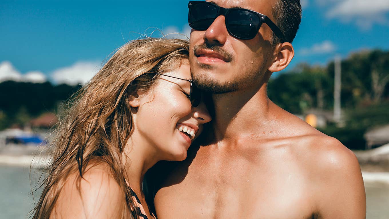 woman flirting with man at the beach