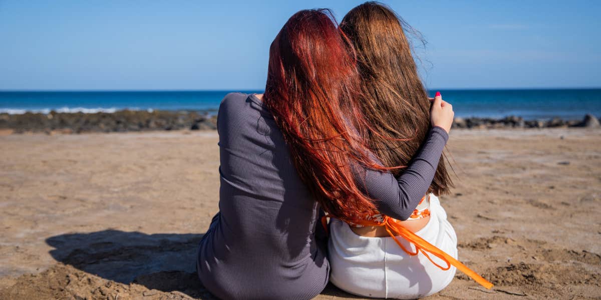 hugging best friends on beach