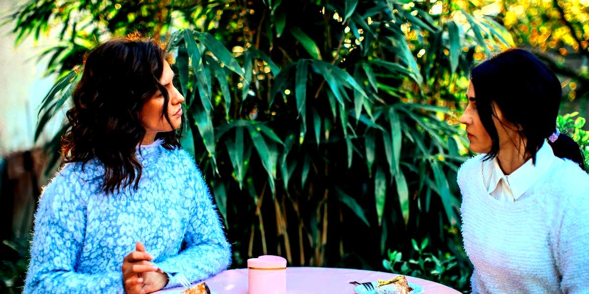 two women talking over a meal