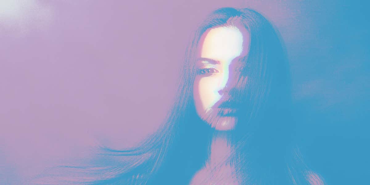 15 Spiritual & Psychic Signs Someone Is Thinking About You woman with hair covering part of her face