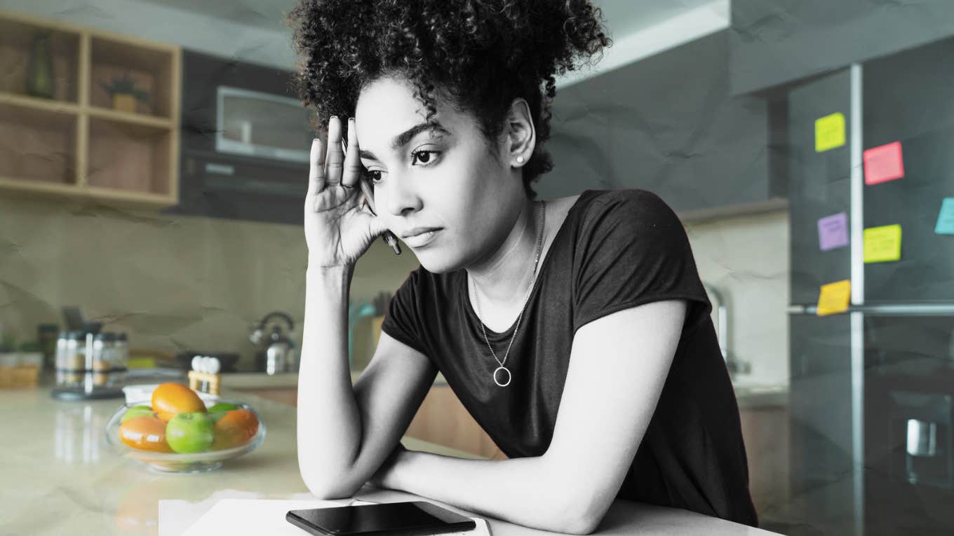 Woman disassociating at kitchen island 