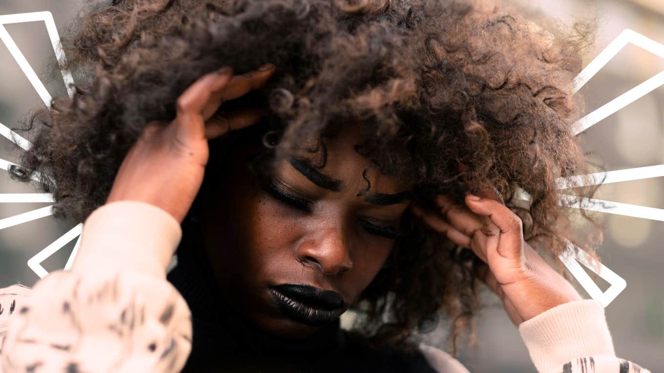 Stressed woman with hands on her head 