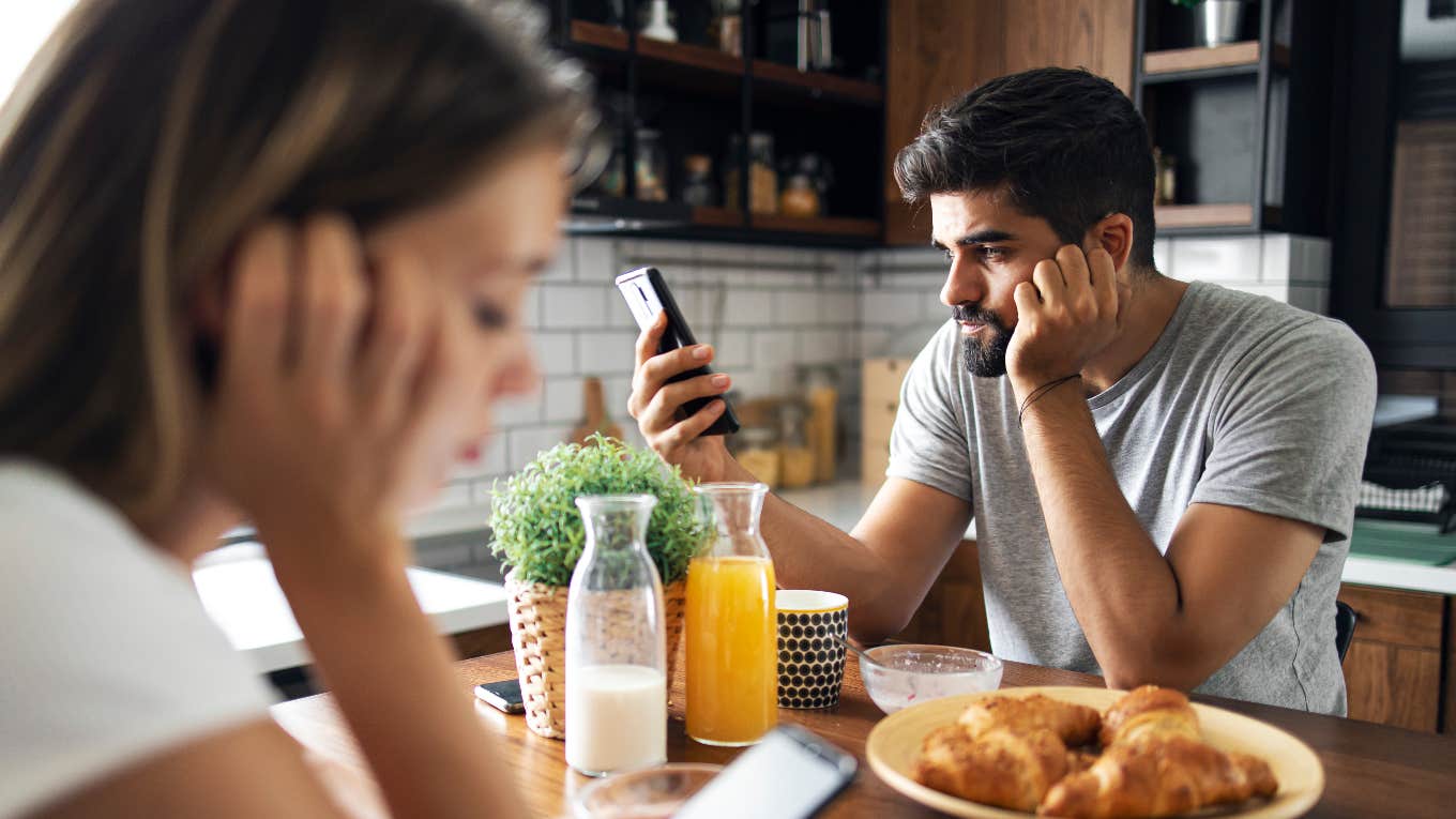 couple on phones ignoring each other at breakfast table