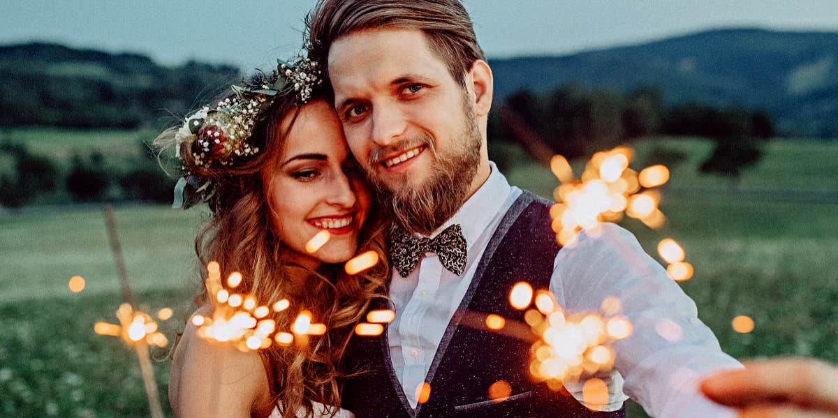 man and woman with sparklers