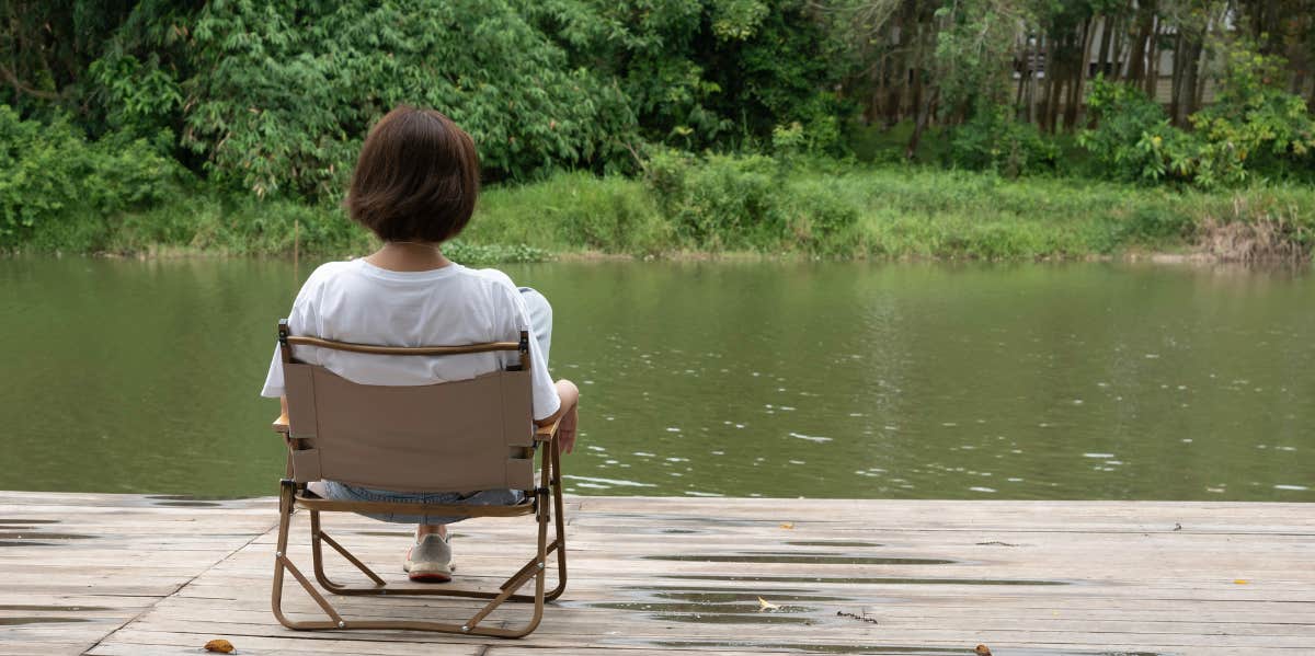 woman sitting near river