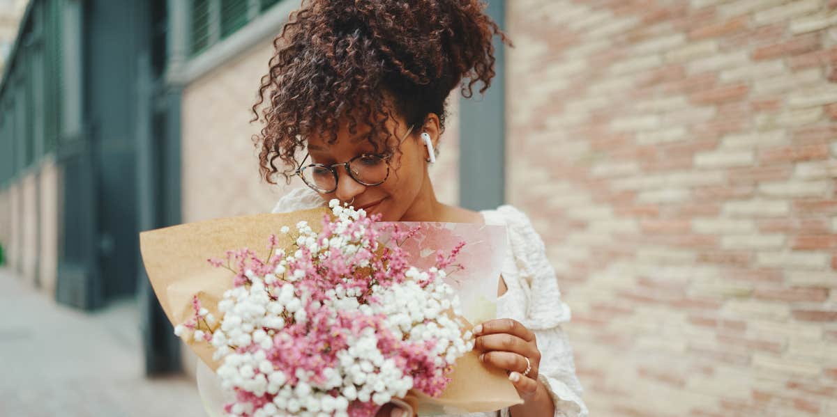woman smelling flower bouquet 