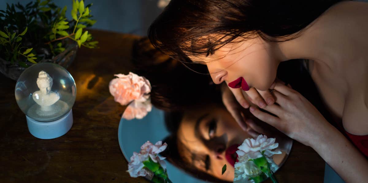 woman admiring herself in the mirror