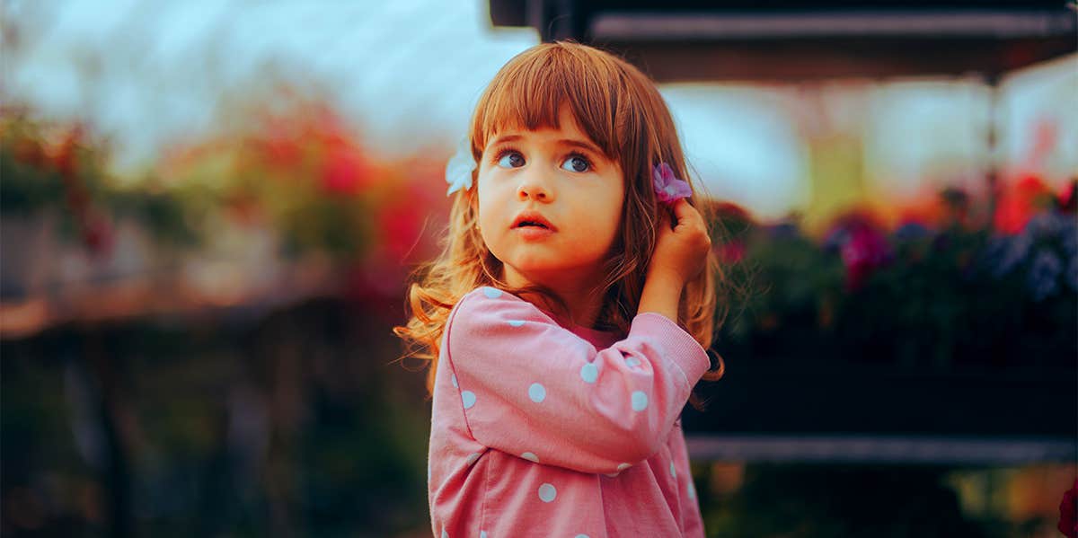 Signs Your Child Has A 'Highly Sensitive' Brain, According To Parenting Experts little girl in garden