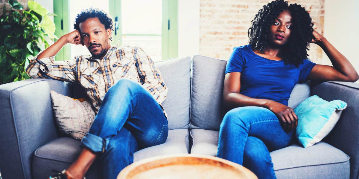 unhappy marriage couple sitting on a couch not looking at each other