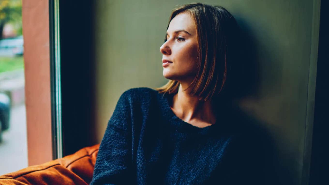 woman looking out a window