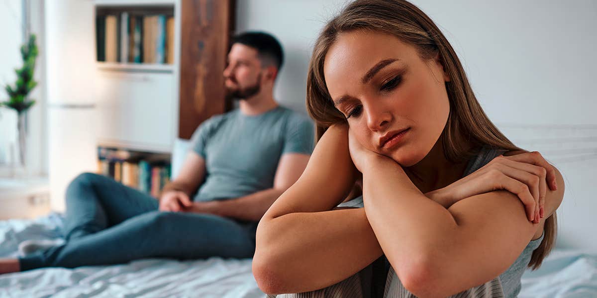 unhappy couple on bed