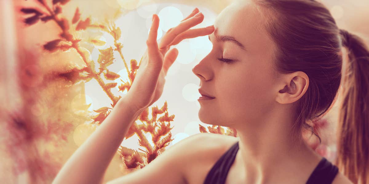 woman touching the center of her forehead