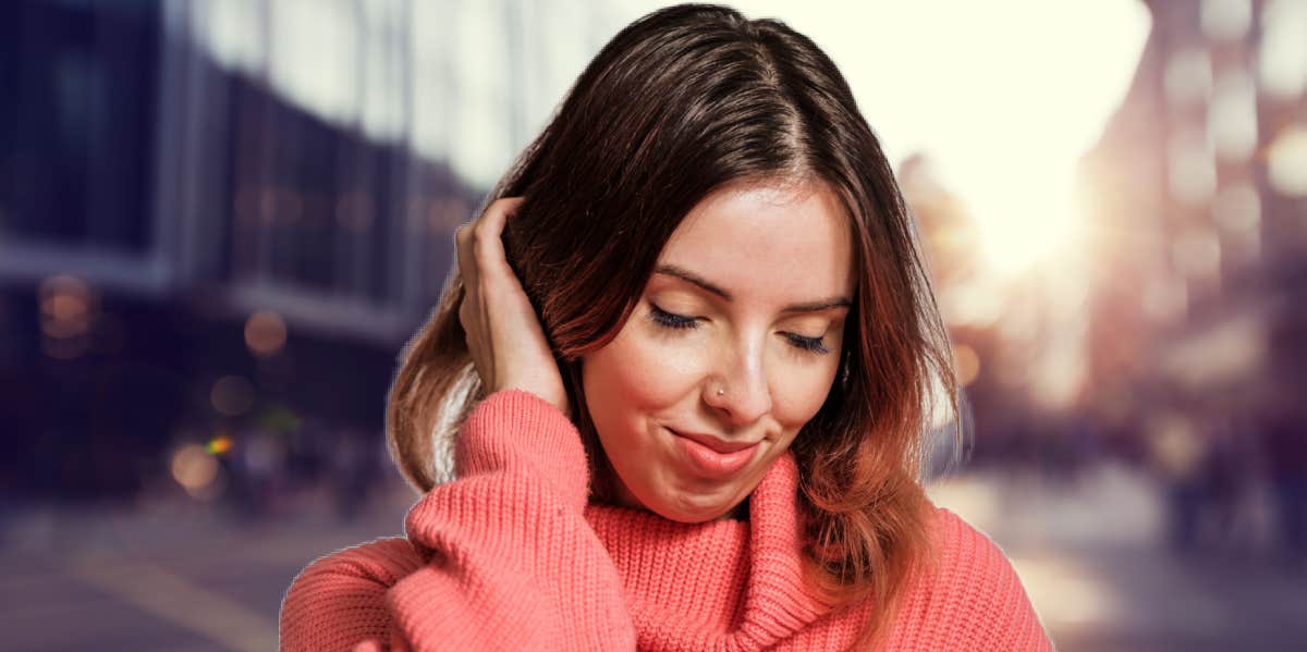 woman smiling touching her head