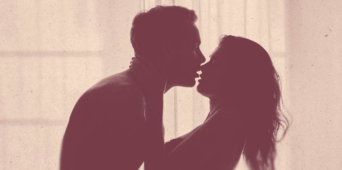 woman and man kissing in silhouette