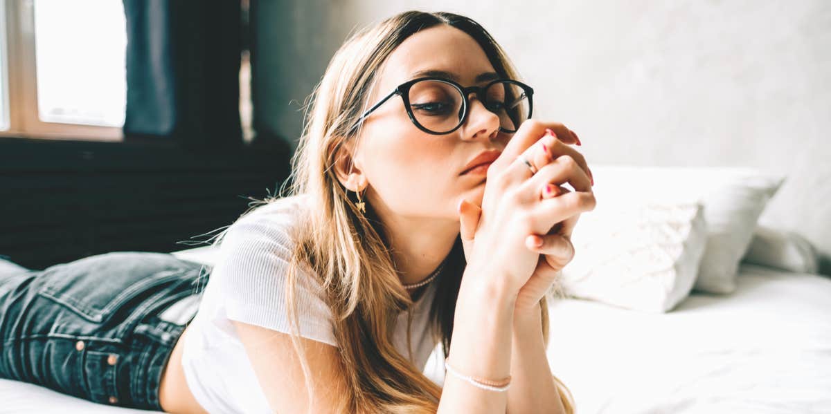 Signs You're Stuck In The Past And How To Move Forward woman thinking on the bed