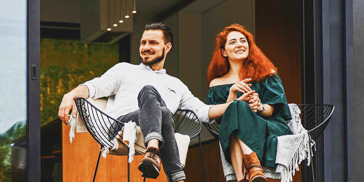 couple sitting on a deck, comfortably quiet