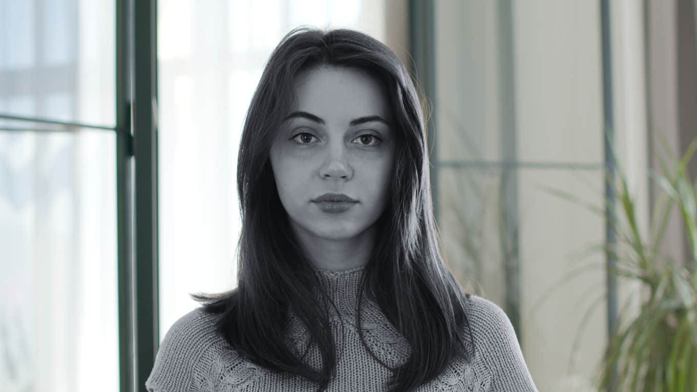 It Took Me 20 Years To Reveal My Most Shameful Secret Woman standing stoically