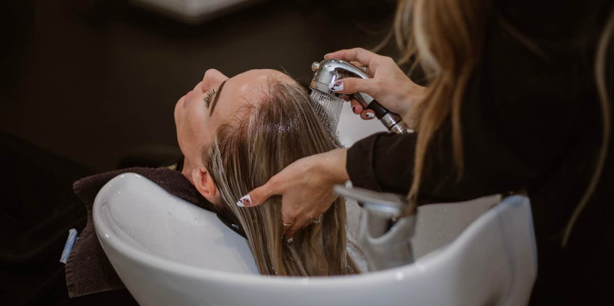 woman getting hair done at salon