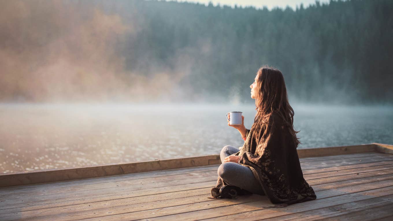 Woman sitting in nature, in her own thoughts