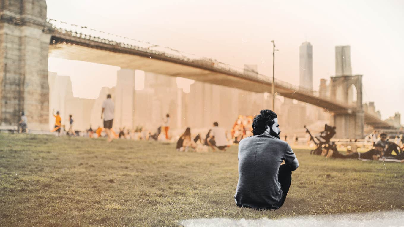 Man sitting in park observing the people 