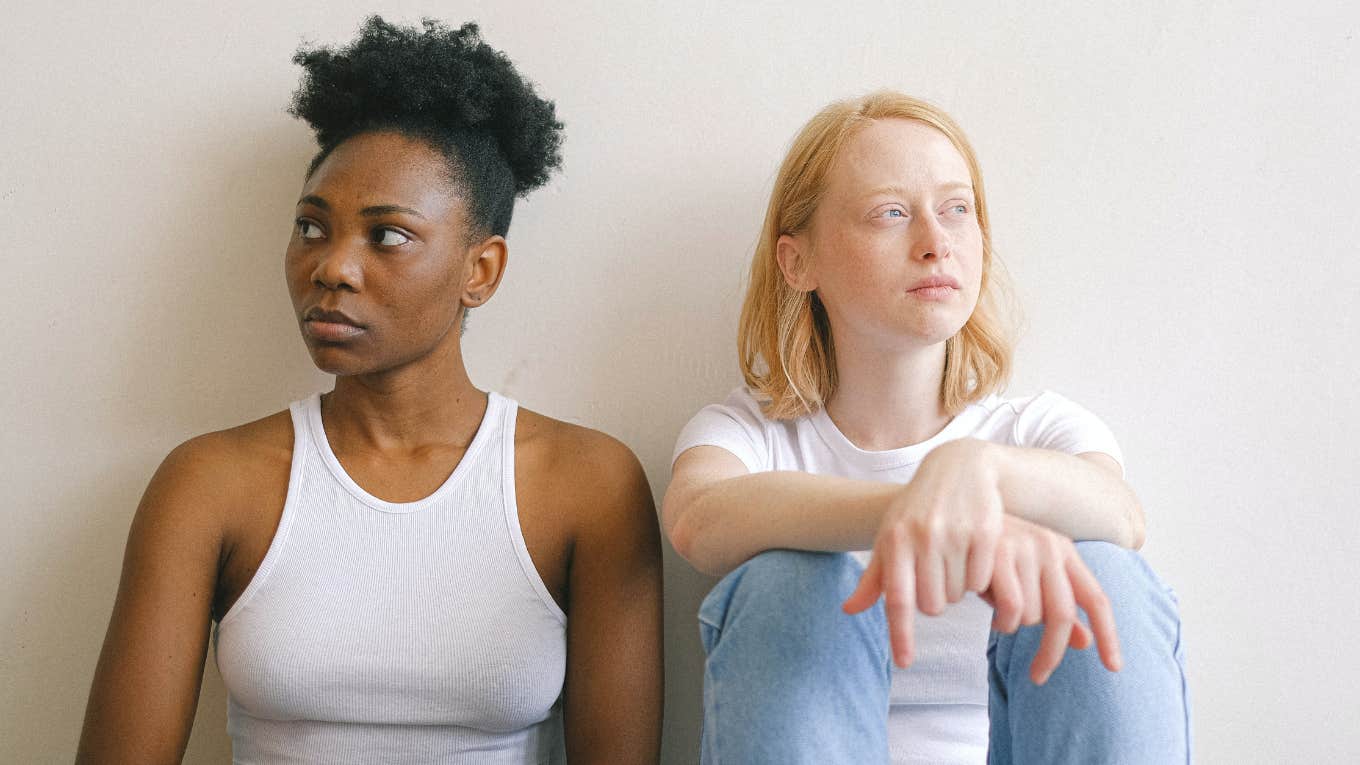 two women sitting next to each other 