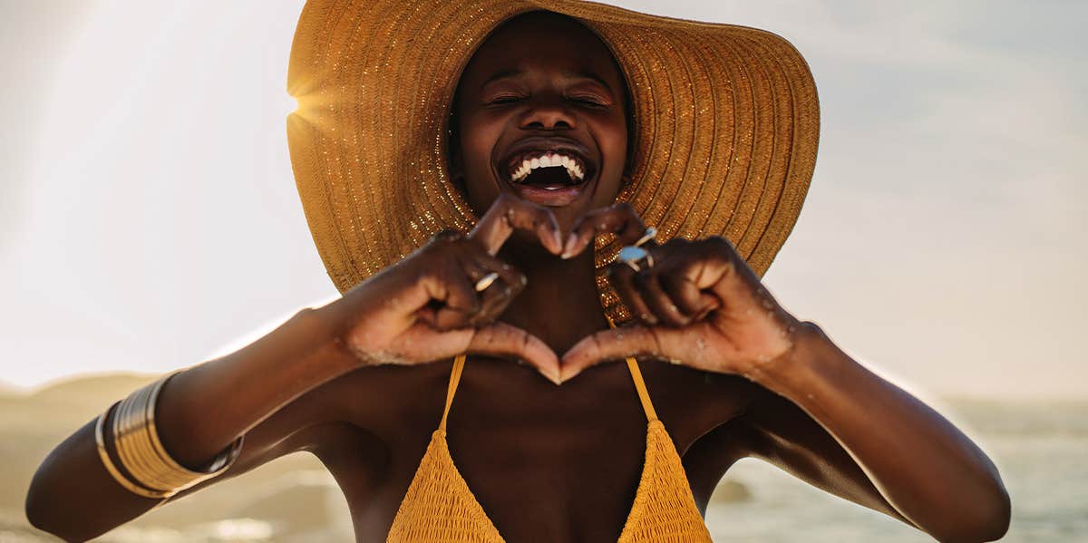 woman making heart shape with hands