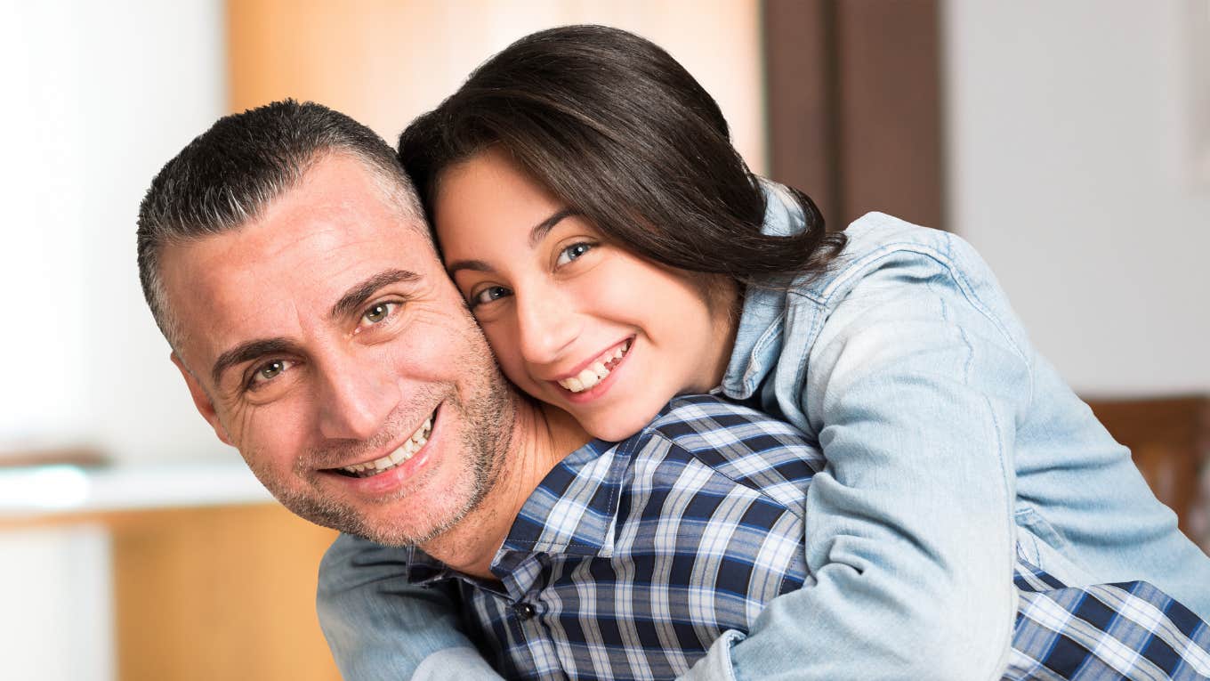 dad and tween daughter smiling