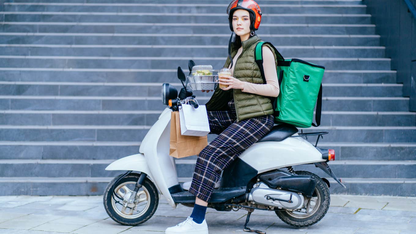 woman on moped delivering food