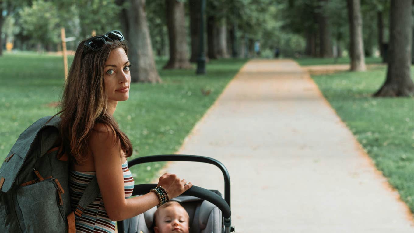 mom pushing baby in stroller 