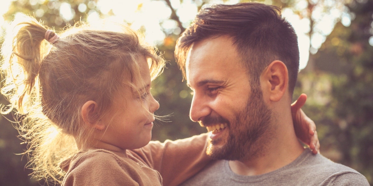 father and young daughter laughing